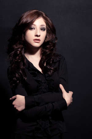 woman fashion model posing over blackの写真素材
