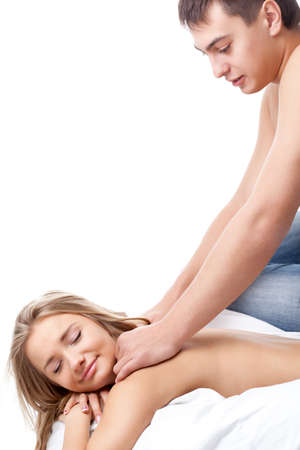 young adult couple lying on white bedの写真素材
