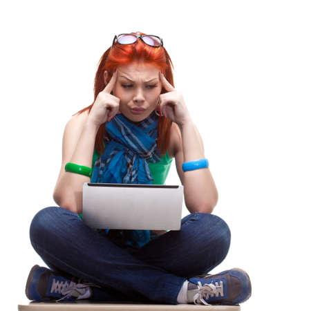 happy girl sitting with laptop over whiteの写真素材