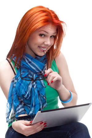 happy girl sitting with laptop over whiteの写真素材