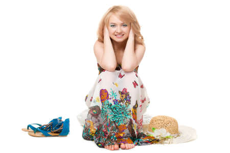 blond pretty woman posing wearing summer dress over white studio portraitの写真素材