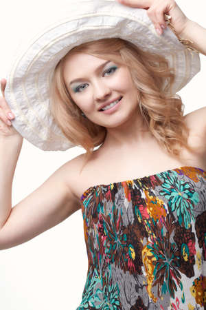 blond pretty woman posing wearing summer dress over white studio portraitの写真素材