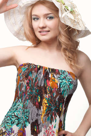 blond pretty woman posing wearing summer dress over white studio portraitの写真素材