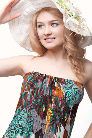 blond pretty woman posing wearing summer dress over white studio portraitの写真素材