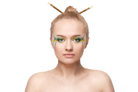 woman face with bamboo leaves style makeup over whiteの写真素材