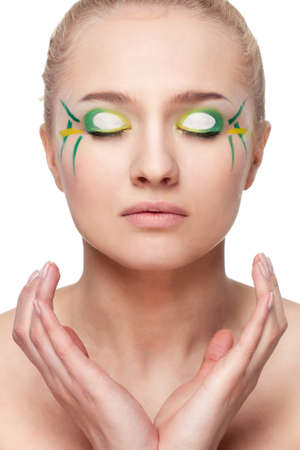 woman face with bamboo leaves style makeup over whiteの写真素材