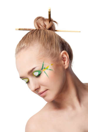 woman face with bamboo leaves style makeup over whiteの写真素材
