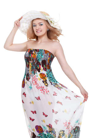 blond pretty woman posing wearing summer dress over white studio portraitの写真素材