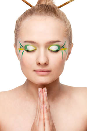 woman face with bamboo leaves style makeup over whiteの写真素材