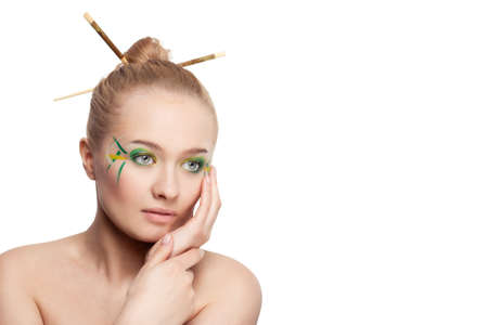 woman face with bamboo leaves style makeup over whiteの写真素材
