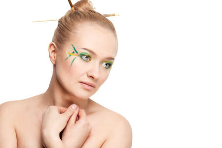 woman face with bamboo leaves style makeup over whiteの写真素材