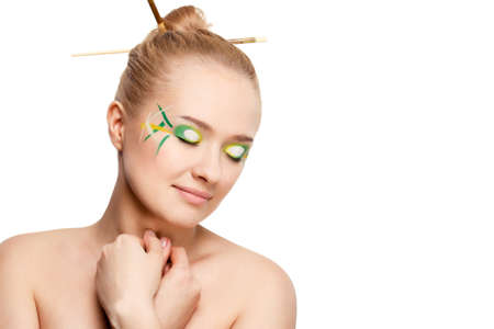 woman face with bamboo leaves style makeup over whiteの写真素材