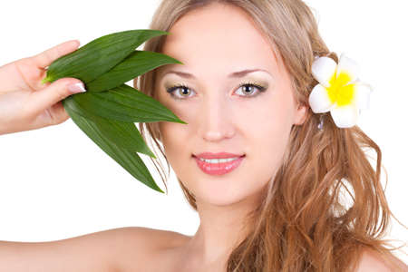 beautiful blond woman closeup face with green leaves over whiteの写真素材