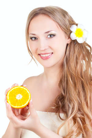 beautiful blond  woman holding orange slice over whiteの写真素材