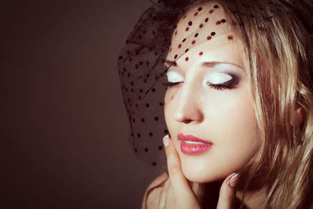closeup woman face retro styled studio portraitの写真素材