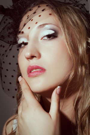 closeup woman face retro styled studio portraitの写真素材