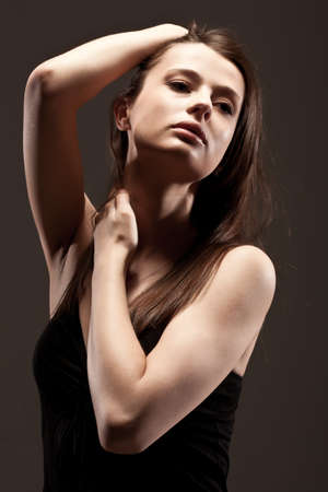beautiful woman  closeup studio portrait, toned over dark backgroundの写真素材