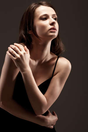 beautiful woman  closeup studio portrait, toned over dark backgroundの写真素材