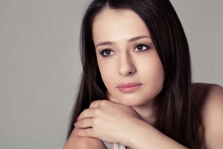 beautiful brunette woman closeup face studio portraitの写真素材