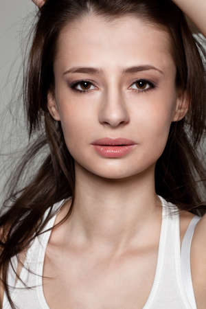 beautiful brunette woman closeup face studio portraitの写真素材