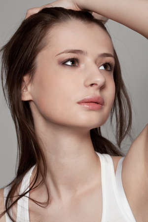 beautiful brunette woman closeup face studio portraitの写真素材