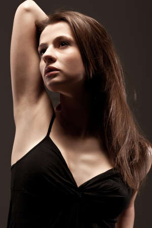 beautiful woman  closeup studio portrait, toned over dark backgroundの写真素材