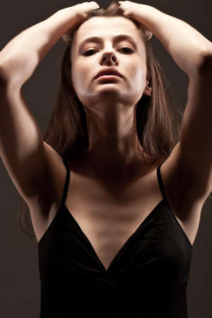 beautiful woman  closeup studio portrait, toned over dark backgroundの写真素材