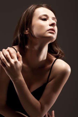 beautiful woman  closeup studio portrait, toned over dark backgroundの写真素材