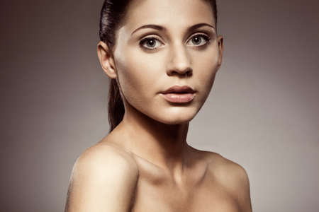 beautiful woman closeup face  and shoulders studio portraitの写真素材