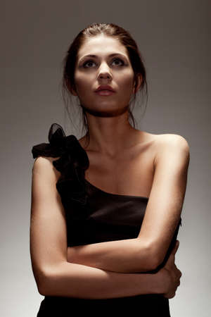 woman wearing black dress, studio portrait over gradient backgroundの写真素材