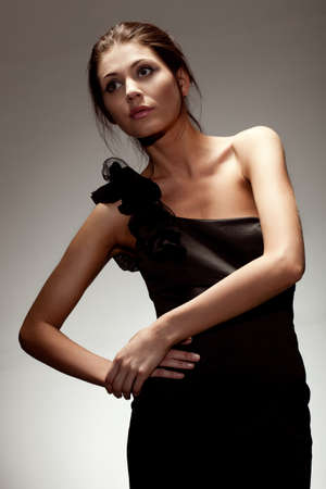 woman wearing black dress, studio portrait over gradient backgroundの写真素材