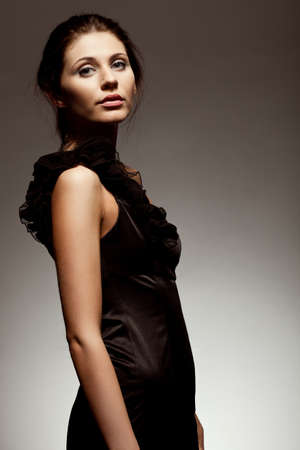 woman wearing black dress, studio portrait over gradient backgroundの写真素材