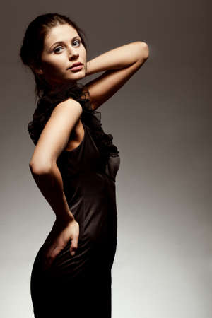 woman wearing black dress, studio portrait over gradient backgroundの写真素材