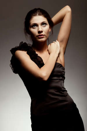 woman wearing black dress, studio portrait over gradient backgroundの写真素材