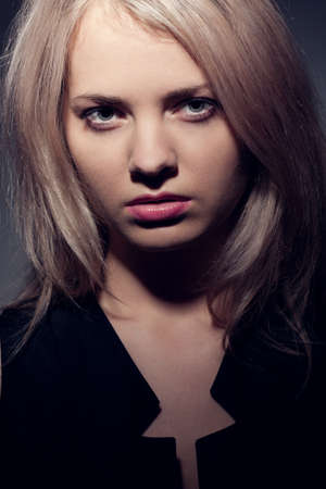 closeup woman face portrait over darkの写真素材