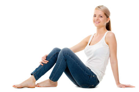 beautiful woman sitting on the floor over whiteの写真素材
