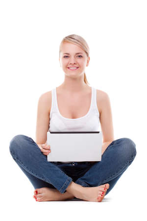 woman sitting on the floor with laptop, studio shot over whiteの写真素材