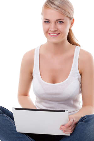 woman sitting on the floor with laptop, studio shot over whiteの写真素材