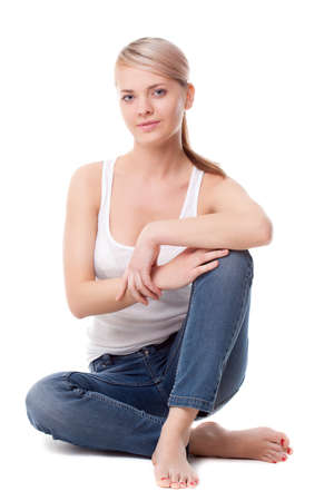beautiful woman sitting on the floor over whiteの写真素材