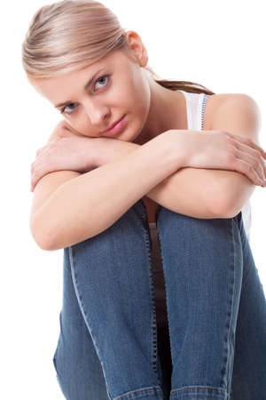 beautiful woman sitting on the floor over whiteの写真素材