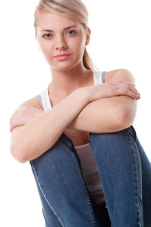 beautiful woman sitting on the floor over whiteの写真素材