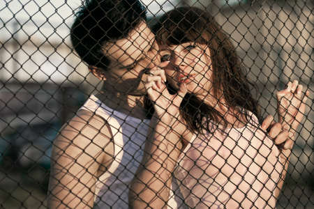 embaring couple standing near latticeの写真素材