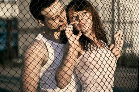 embaring couple standing near latticeの写真素材