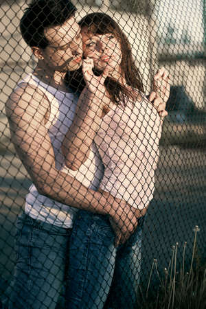 embaring couple standing near latticeの写真素材