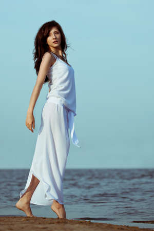 beautiful woman on  on the sea beach weraing white dressの写真素材