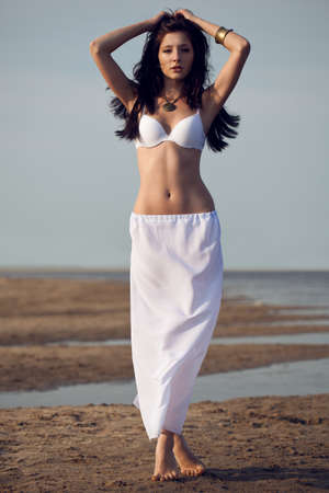 beautiful woman on  on the sea beach wearing whiteの写真素材