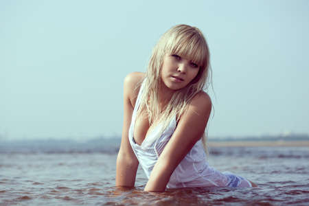 beautiful blonde sexy woman in waterの写真素材