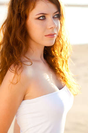 closeup red-haired woman portrait outdoorsの写真素材