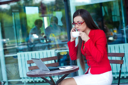 beautiful brunette businesswoman  in outdoors cafeの写真素材