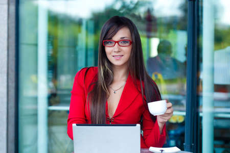 beautiful brunette businesswoman  in outdoors cafeの写真素材